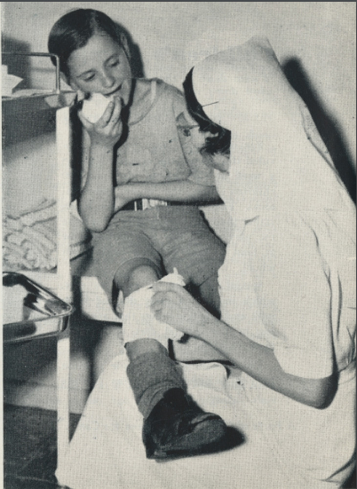 This is a photo of a nurse helping a child at the Children’s Health Clinic in 1952