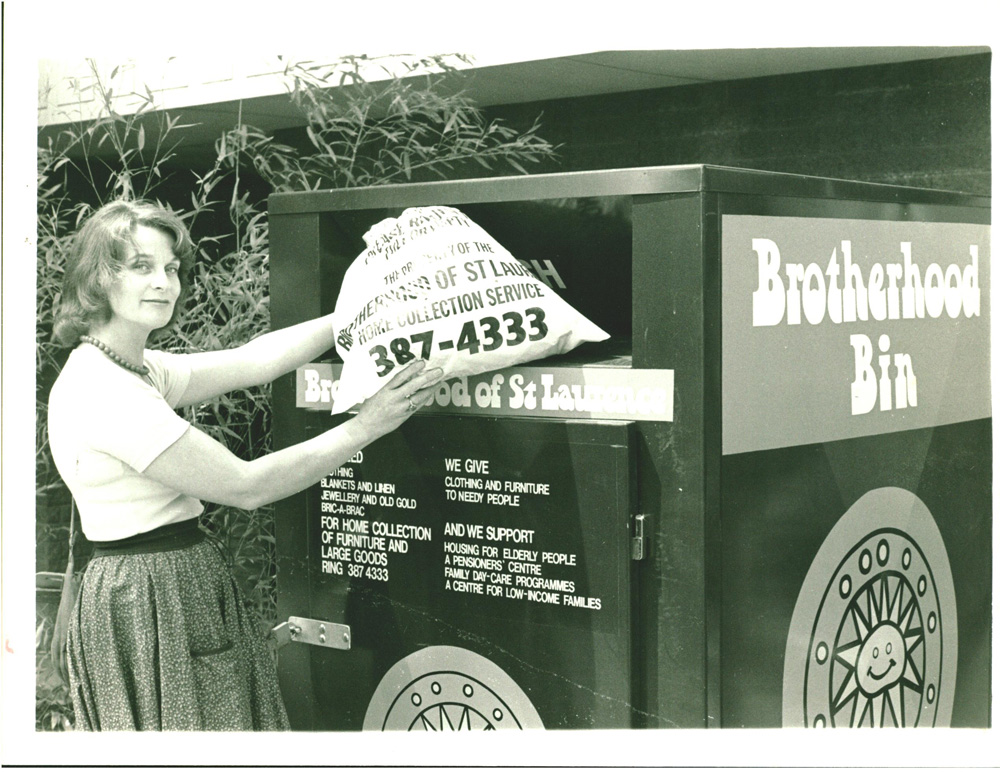 This is a photo of a woman putting her home collection bag into a Brotherhood Bin. She is donating used goods.